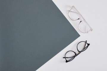 Canvas Print - trendy stylish eye glasses on a gray background, geometry background copy space, top view