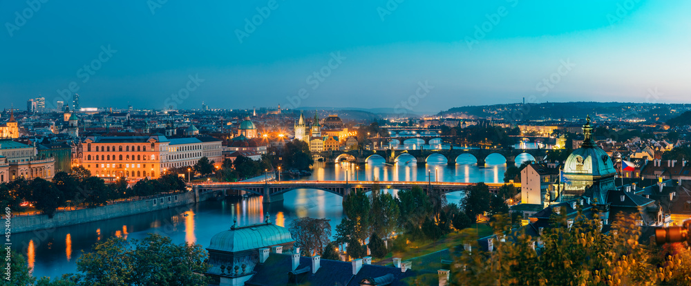 Prague, Czech Republic. Evening Panoramic View Of Evening Cityscape In Night Lighting. Charles Bridge, Manes Bridge, Straka Academy. Famous Landmarks, UNESCO World Heritage - obrazy, fototapety, plakaty 
