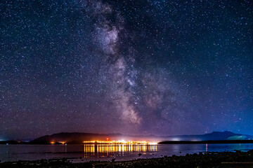 Wall Mural - night view to small town at Mount Waddington many stars on dark sky.