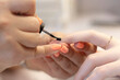 © Nataliya - The process of manicure in a beauty salon by a specialist, with a copy of the space. Close-up