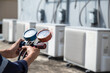 © A Stockphoto - Technician is checking air conditioner ,measuring equipment for filling air conditioners , service and maintenance air conditioner .