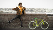 © Alessandro Biascioli - Happy African man having fun with bike in the city - Youth millennial generation lifestyle concept