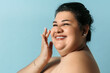 Plus size hispanic woman healthy skin. Smiling adult woman with skin care.