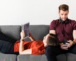 © Rawpixel.com - Antisocial couple relaxing on the sofa