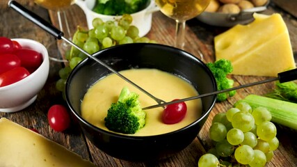 Wall Mural - cheese fondue with vegetables and glasses of wine