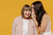 © ViDi Studio - Two young smiling daughter mother together couple women wearing casual beige clothes whisper gossip and tell secret behind her hand sharing news isolated on plain yellow background studio portrait
