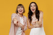 © ViDi Studio - Two young daughter mother together couple women in casual beige clothes point index fingers camera on you laughing joking isolated on plain yellow background studio portrait. Family lifestyle concept.