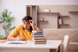 © Elnur - Young male student preparing for exams at home