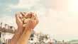 © Vivvi Smak - Hands in a heart shape at Lyme Regis touristic beach in July middle of summer in the United Kingdom