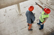 © Seventyfour - Top view at two construction workers wearing hardhats at costruction site, copy space
