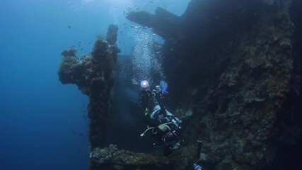 Wall Mural - Underwater photographer takes pictures of the shipwreck. USAT Liberty wreck in Tulamben, Bali island, Indonesia