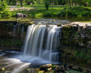 Wall Mural - idyllic river landscape in the forest with a waterfall