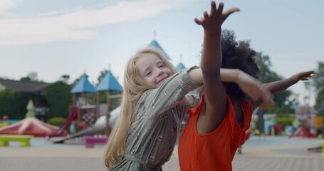 Wall Mural - Diverse happy kids hugging on children playground