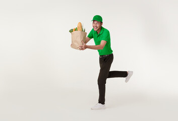 Asian delivery man wearing in green uniform holding fresh food paper bag and running isolated over white background..express delivery concept.