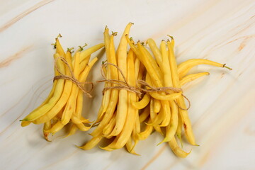 Raw Organic Yellow String Beans in a bunch on white background. Organic yellow wax bean on a table.Freshly harvested vegetables, organic food concept