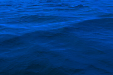 Background of a blue water surface with waves