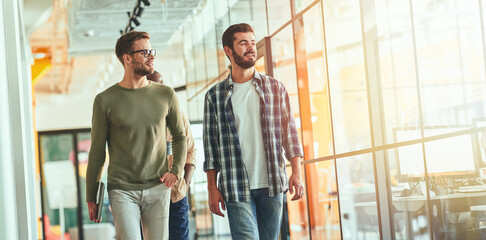 Two brunette male colleagues headed to to work together