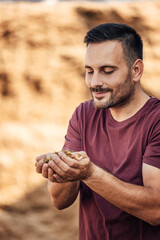 Wall Mural - Adult man, making sure the wheat is edible.