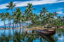 Vintage Hawaiian Outrigger Canoe On The Water Next To Palm Trees. 