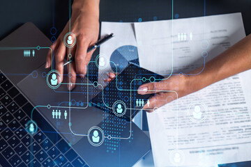 Hands of woman hr specialist is typing the keyboard in the internet to find the best candidates to create international network in recruitment process. Casual wear. Social media hologram icons.