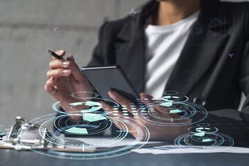 Wall Mural - Businesswoman is signing the contract to create fin-tech start up for the conference and gain investments for innovative service. Checking the details at smartphone. Hologram tech graphs.