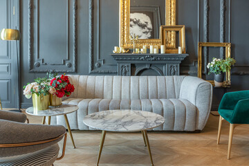 chic interior of the room in the Renaissance style of the 19th century with modern luxury furniture. walls of noble dark color are decorated with stucco and gilded frames, wooden parquet.