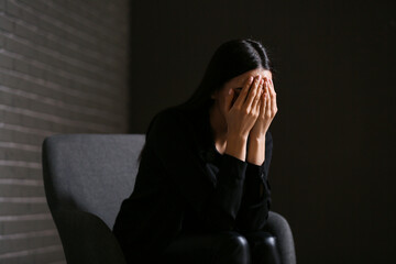 Sticker - Young depressed businesswoman in dark office