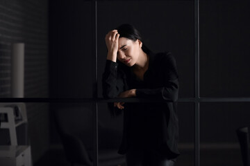 Sticker - Young depressed businesswoman in dark office