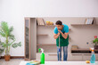 © Elnur - Young male contractor cleaning the house
