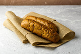 Fototapeta Kuchnia - two fresh rye buns on burlap on a gray background
