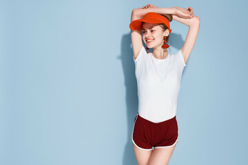 Poster - woman in white t-shirt red cap fashion summer style posing blue background