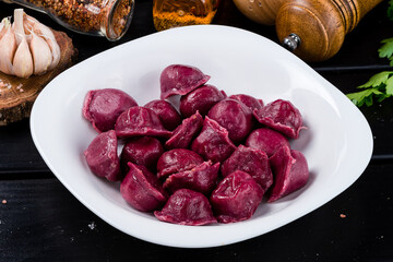 Poster - Tasty beetroot ravioli, Beetroot ravioli stuffed with baked beets and meat. Vegetarian food. Colored dumplings in a white plate