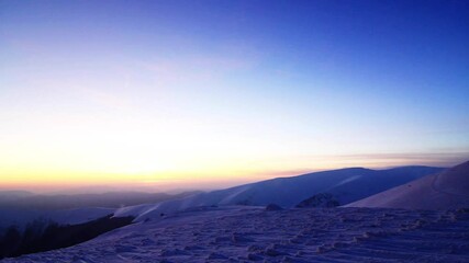 Golden sun touching mountain on sunset. Winter in mountains. Ukraine Carpathians Dragobrat