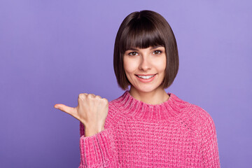 Canvas Print - Photo of good mood smiling female point finger copyspace advertise product offer isolated on purple color background