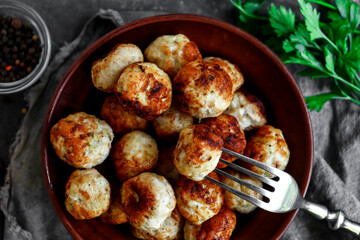 Wall Mural - Chicken meatballs in a plate. Meatballs and basil. Copyspace. Top view.