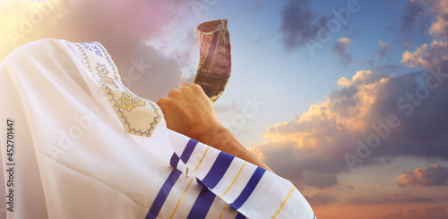 Jewish man blowing the Shofar (horn) of Rosh Hashanah (New Year). Religious symbol