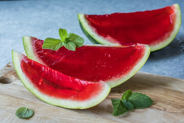 Wall Mural - Homemade watermelon and mint dessert. Jelly in a watermelon  on a light background.