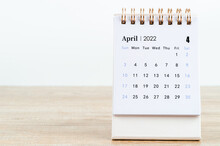 April Calendar 2022 On Wooden Table.