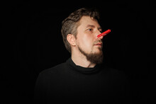 Bearded Prankster With Clothespin On Nose. Funny Joke Concept.