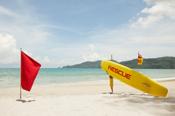 Wall Mural - Close up view of rescue surf board on tropic beach background