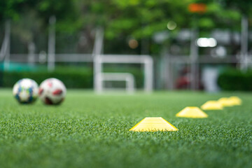 Obstacle cone for speed and moving training on artificial turf ground for football training. Sport equipment object photo. Selectived focus at the front cone.