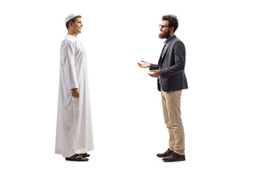 Wall Mural - Full length profile shot of a young man in white ethnic clothes and a bearded man having a conversation