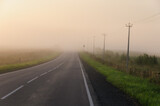 Fototapeta Tęcza - Landscape overlooking a foggy road