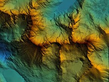 Digital Elevation Model. GIS Product Made After Proccesing Aerial Pictures Taken From A Drone. It Shows High Rocky And Steep Mountain Peaks. At Their Feet Are Visible Valleys And Mountain Lakes