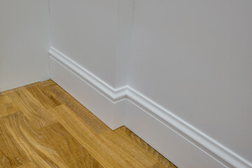 Wall Mural - Detail of corner flooring with intricate crown molding and plinth.