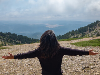 Wall Mural - woman with open arms on the mountain as a sign of freedom