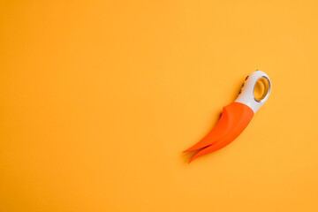 Sex toy. Orange vibrator for women on a yellow background. Useful for adult, sex shop