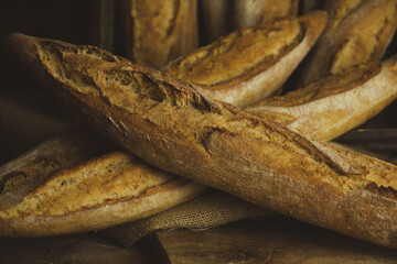 Sticker - Closeup shot of fresh baguettes on a wooden board