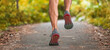 © Maridav - Running shoes man runner athlete workout on city park park path closeup of feet and legs banner panoramic. Outdoor training.