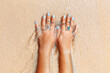 beautiful young woman hand with many rings at sea shore background close up
